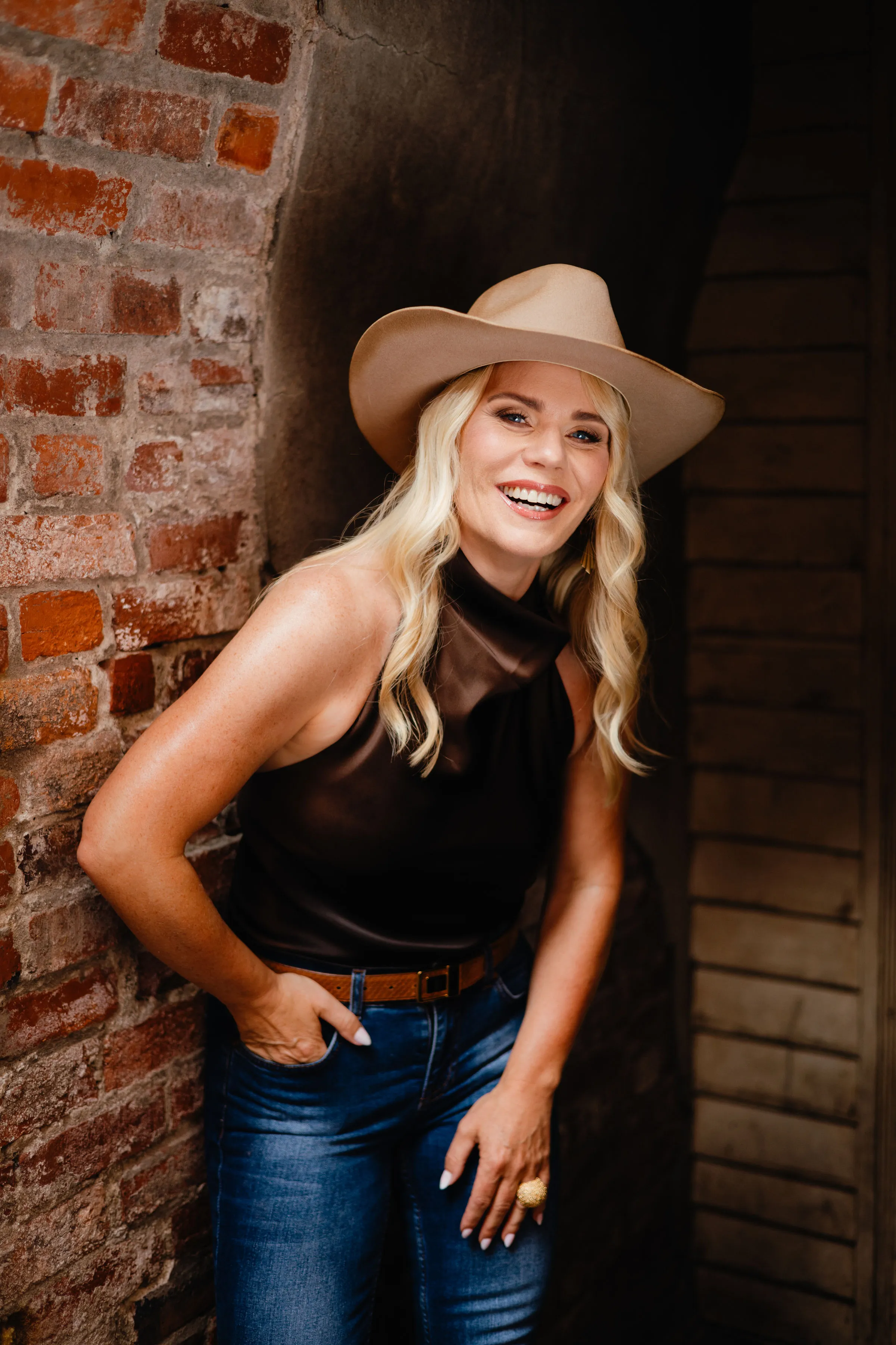 Carina Dahlmann smiling in front of a red brick wall