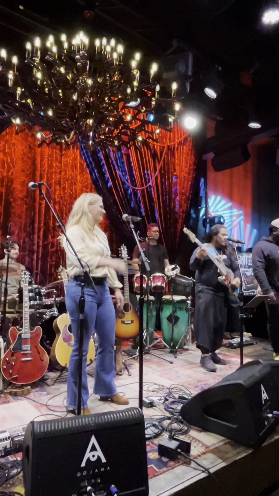 Carina on stage at the Pitch Meeting at Analog, backed by the house band