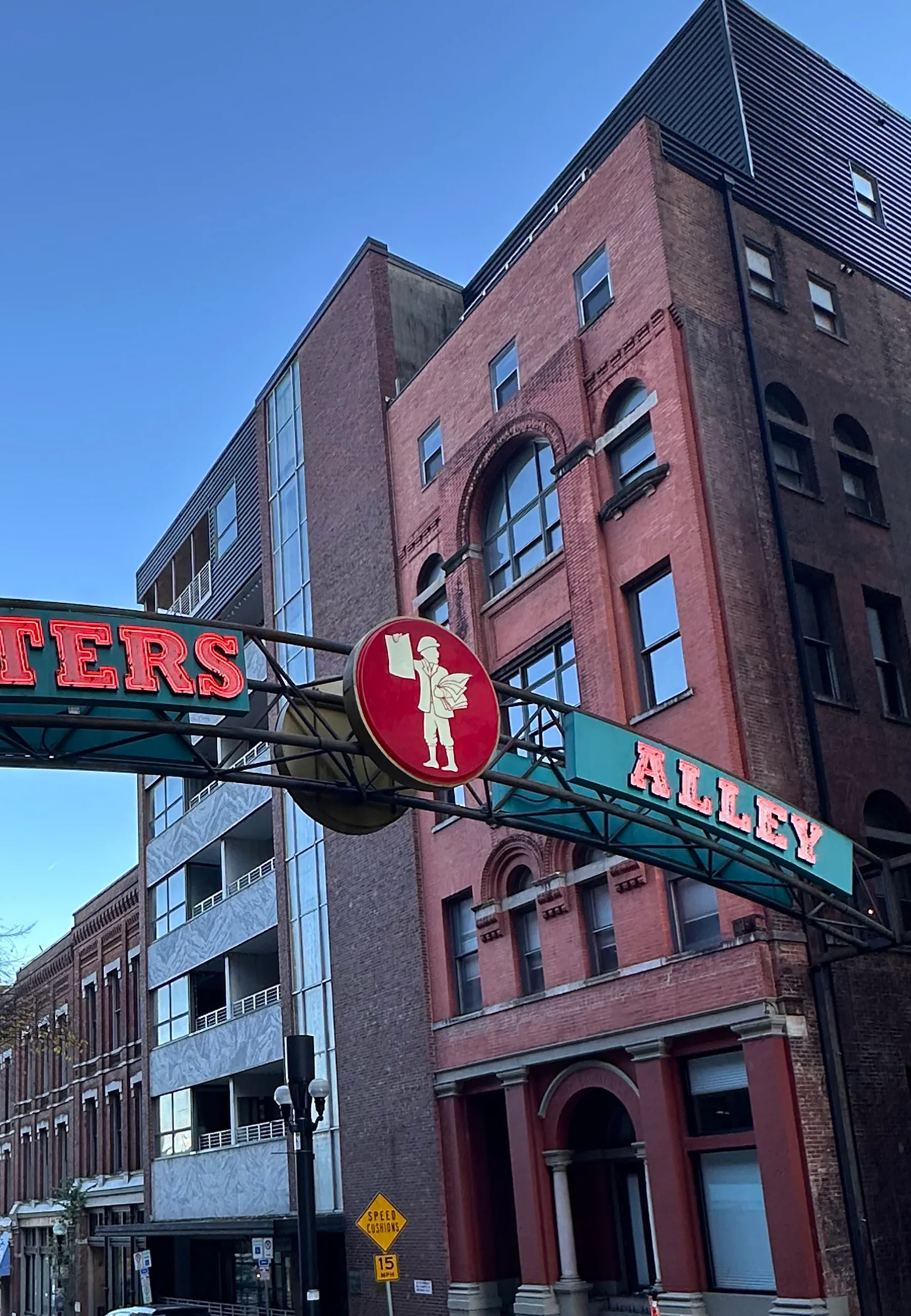 The neon-lit entrance to Printer's Alley at night