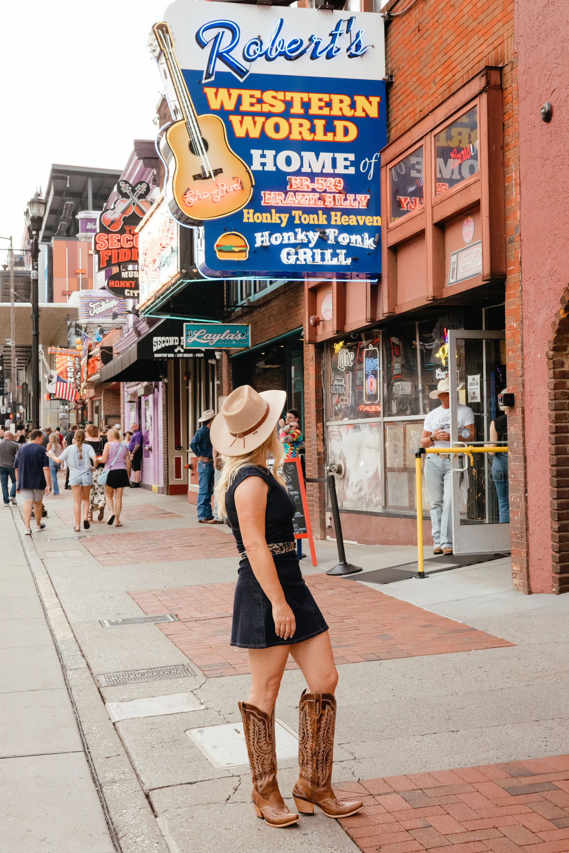 Carina Dahlmann on Lower Broadway beneath the Robert's Western World guitar sign